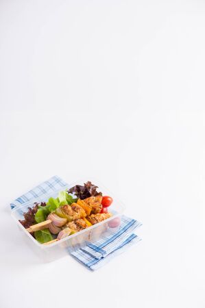 Chicken breast barbecue cooked by clean food concept and vegetables in lunch box on white tableの写真素材