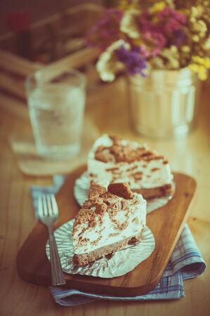 Chocolate cookie cheese cake on wood table with film filter effectの写真素材
