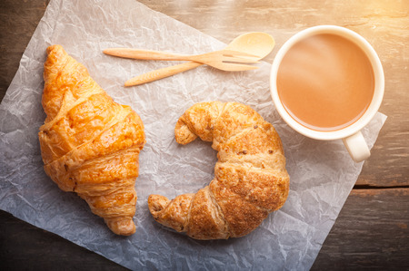 Butter croissant and whole wheat croissant on wood table with morning sceneの写真素材