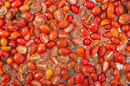 Cherry tomatoes with herbs preparing for dry out with sun lightの写真素材