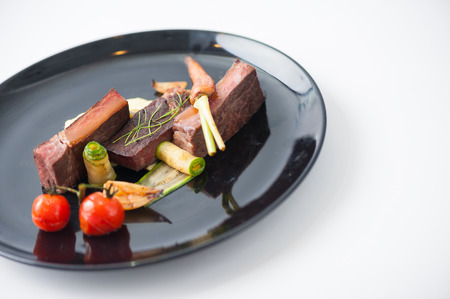 Dry-aged beef steak with mesh potato and vegetable, a modern style foodの写真素材