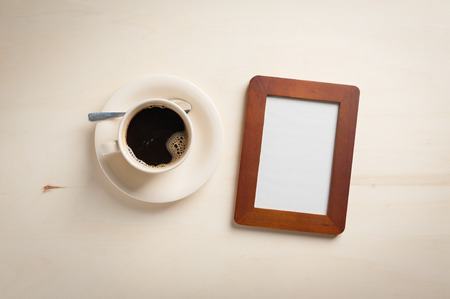 Photo frame with blank area and coffee cup on wood tableの写真素材