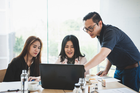 Asian businesspeople discussing and brainstorm about their projects together in meeting room. Business startup teamwork conceptの写真素材