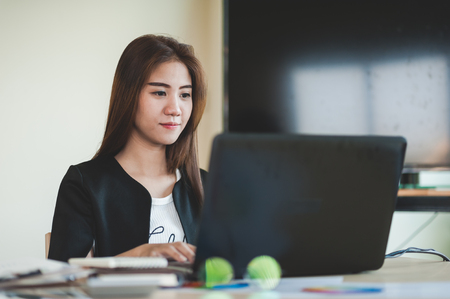 Young Asian secretary female working with laptop computer in office. Business people lifestyle on workdayの写真素材