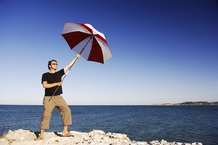 Man With Umbrella At The Beachの写真素材
