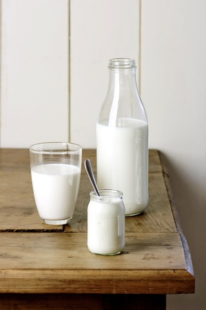 milk, yoghurt, butter and eggs on a wooden tableの写真素材