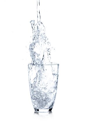 Water Being Poured Into Glass, Blue Tonedの写真素材