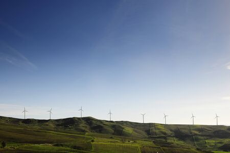 Wind generators, windmills,  on a mountain reignの写真素材