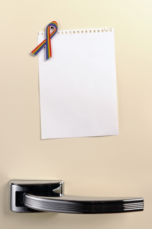 Blank note on fifties fridge door with rainbow awareness ribbon magnet, copyspaceの写真素材