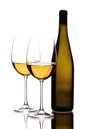 Two glasses of white wine with bottle on white backgroundの写真素材