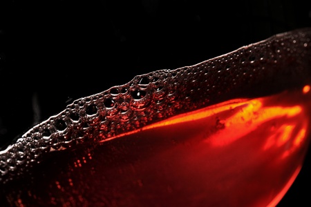 Swiveled red wine in a glass, selective focusの写真素材