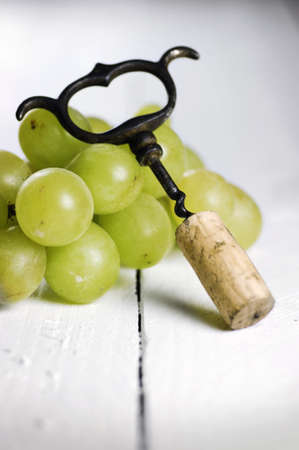 Cork screw and white grapesの写真素材