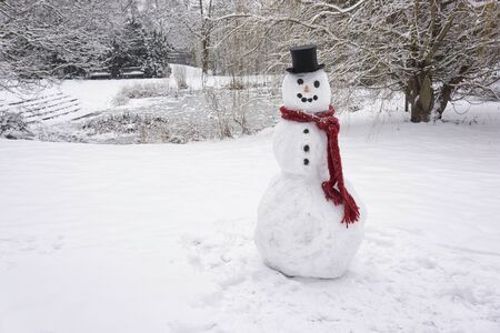 Snowman standing in winter landscapeの写真素材