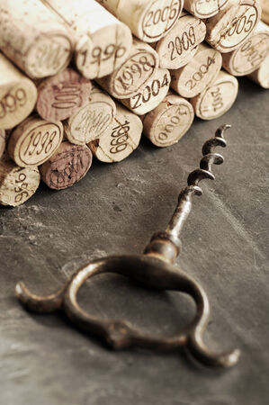 Corks of different years and corkscrew, selective focusの写真素材