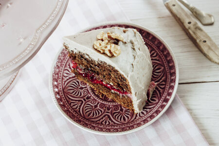 Vegan Walnut Lingonberry Cake with Cashew nut + Almond Frosting, selective focus
