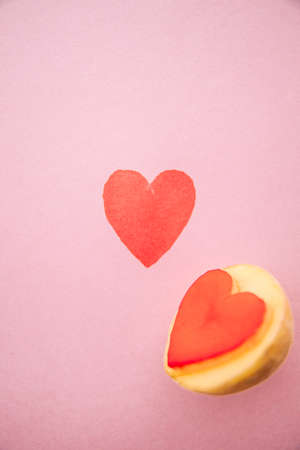 Heart shaped potato stamp on pinkpaper