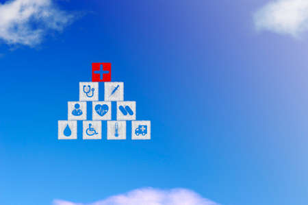 Cloud shape of square block stacking with icon healthcare medical on blue sky.の写真素材