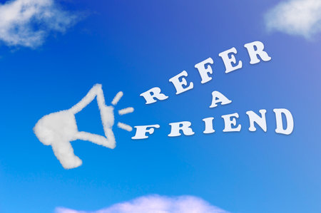Cloud shape of megaphone with a refer a friend concept on blue sky.の写真素材