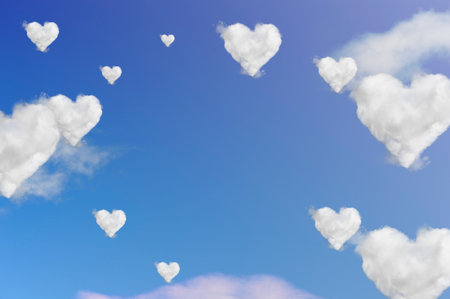 Clouds shape hearts on blue sky. Valentine's day background.の写真素材