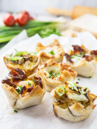 Little bread cups filled with different fillingsの写真素材