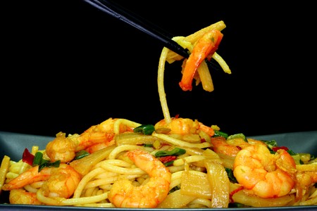 Asian noodles with shrimp and vegetable stir-fry on Asian dishesの写真素材