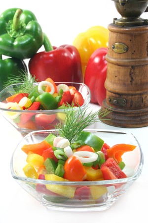 colorful bell pepper salad with dill in small glass bowlの写真素材