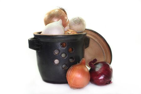 a pot filled with colorful onion bulbsの写真素材