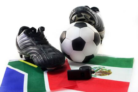 Soccer shoes with flag, leather ball and whistle on a white backgroundの写真素材