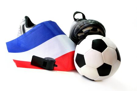 Soccer shoes with flag, leather ball and whistle on a white backgroundの写真素材