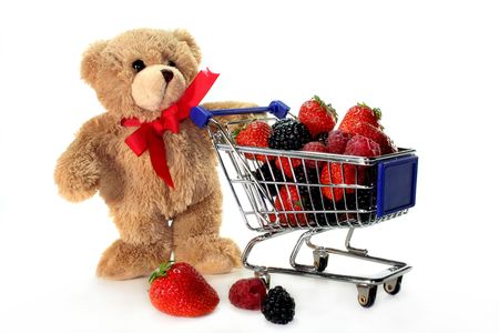 Teddy with shopping carts, laden with delicious berriesの写真素材