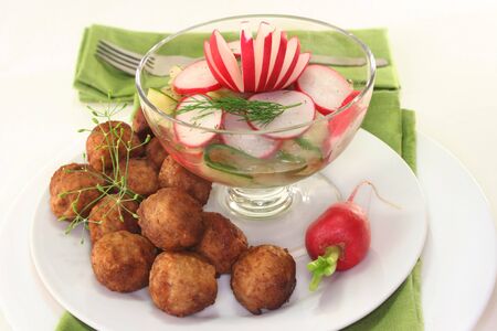 Swedish meatballs with radish-cucumber saladの写真素材
