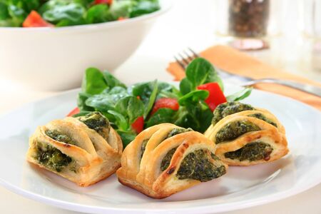 Puff pastry with a spinach-cheese filling and corn saladの写真素材