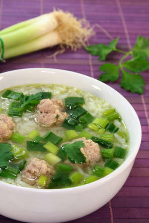 Thai rice soup with meat balls and corianderの写真素材