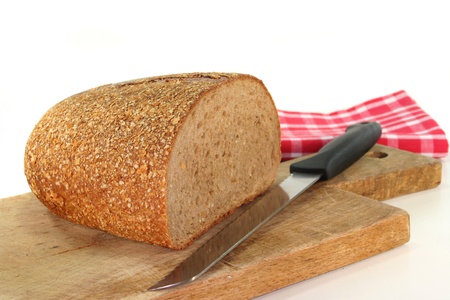 half a loaf of bread on a wooden board