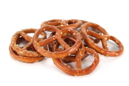 a handful of salt pretzels on a white backgroundの写真素材