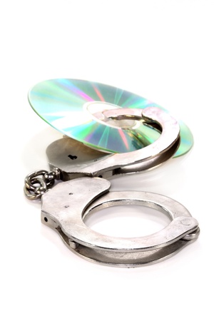 a blank CD with handcuffs on white backgroundの写真素材