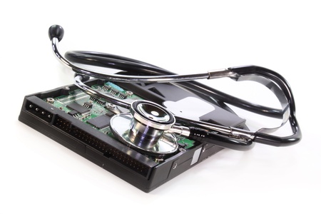 a hard disk and stethoscope on white backgroundの写真素材