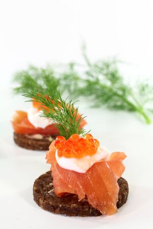 Canapes with smoked salmon, caviar and dillの写真素材