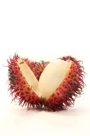 four rambutan fruits on a white backgroundの写真素材