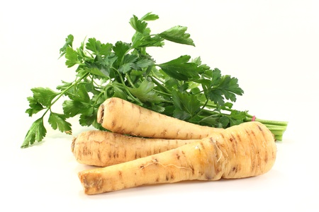Parsnip and parsley on a white backgroundの写真素材