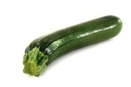 a green zucchini on a white backgroundの写真素材