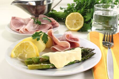 green asparagus with ham and hollandaise sauceの写真素材