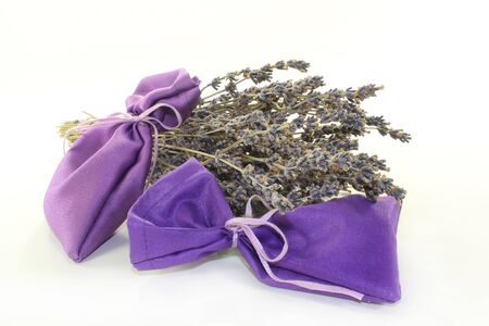 dried lavender flowers and lavender bags against white backgroundの写真素材