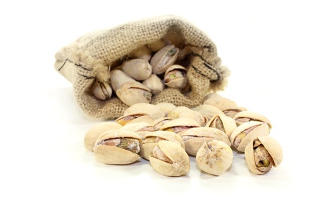 roasted, salted pistachios on a white backgroundの写真素材