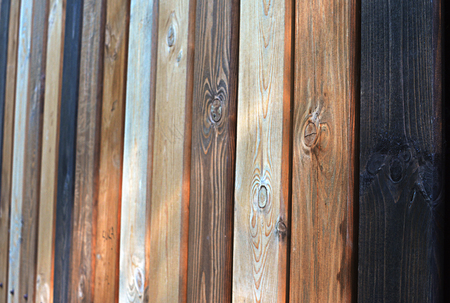 Fence as a background of multi-colored wooden boards, vertical texture in perspectiveの写真素材