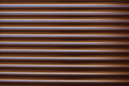 Surface textured horizontal, striped, brown facing wall, sidingの写真素材