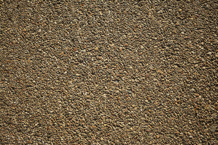 Sand texture motley pebbles on the ground, asphaltの写真素材