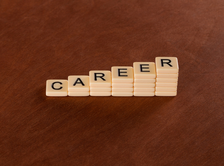 Chart with words Career. Career stair concept. Ivory tiles with capital letters on mahogany board.の写真素材