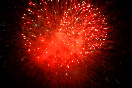 Beautiful red fireworks on the black sky background, celebration, new yearの写真素材
