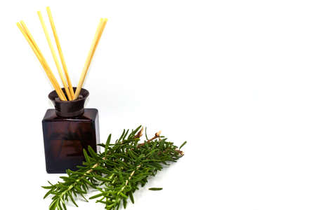 Fresh organic rosemary with essential oil bottle isolated on white background.の写真素材